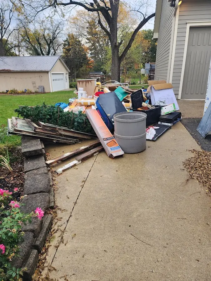 Dumpster being loaded with debris for 10 Yard Dumpster Rental in Moorestown
